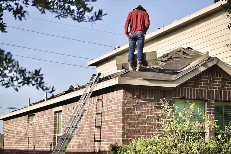 Professional roofer working on a residential roof in Bitter Lake